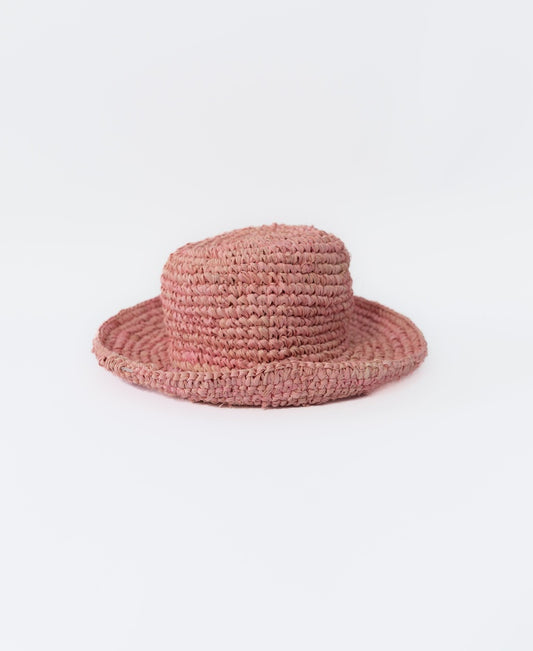 The Lazy Beach LB Raffia Hat with Brim in Blush features a flat crown and wide brim, handmade in Indonesia from woven raffia and shown against a plain white background.