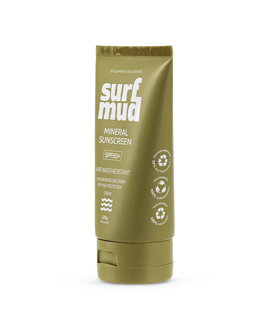 A green tube of Surf Mud Mineral Sunscreen SPF50+ stands upright, displaying white text and icons that highlight its water resistance, broad spectrum protection, and non-nano zinc oxide for gentle sun defense.