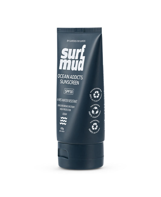 A dark blue tube of Surf Mud Ocean Addicts Sunscreen SPF30 offers mineral-based, water-resistant sun protection for ocean sports, with UVA/UVB defense and vegan-friendly labels on the front.
