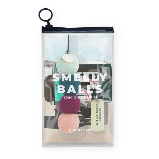 The Smelly Balls Roadie Set Honeysuckle is a clear zippered pouch with travel-themed graphics, holding three colored wool felt balls and a small fragrance oil bottle—your road trip essential.