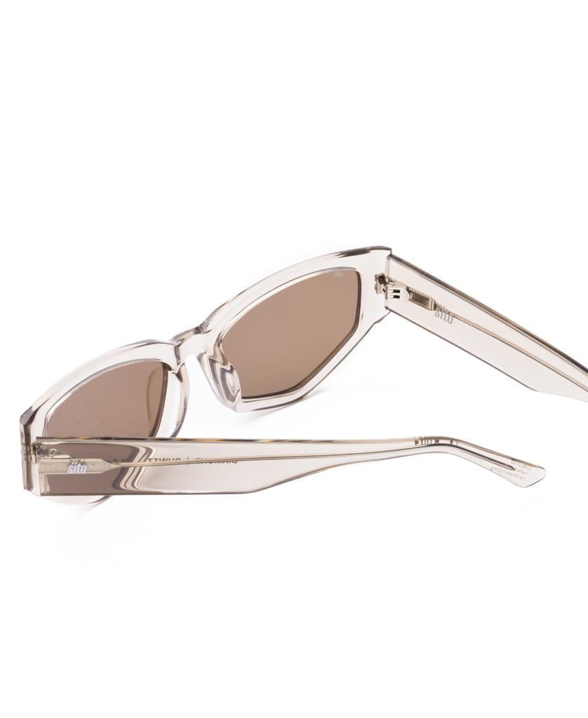 Sito Diamond | Chintz / Coffee sunglasses, featuring a translucent beige frame and brown lenses, are shown on a white background with one arm folded and the other extended.