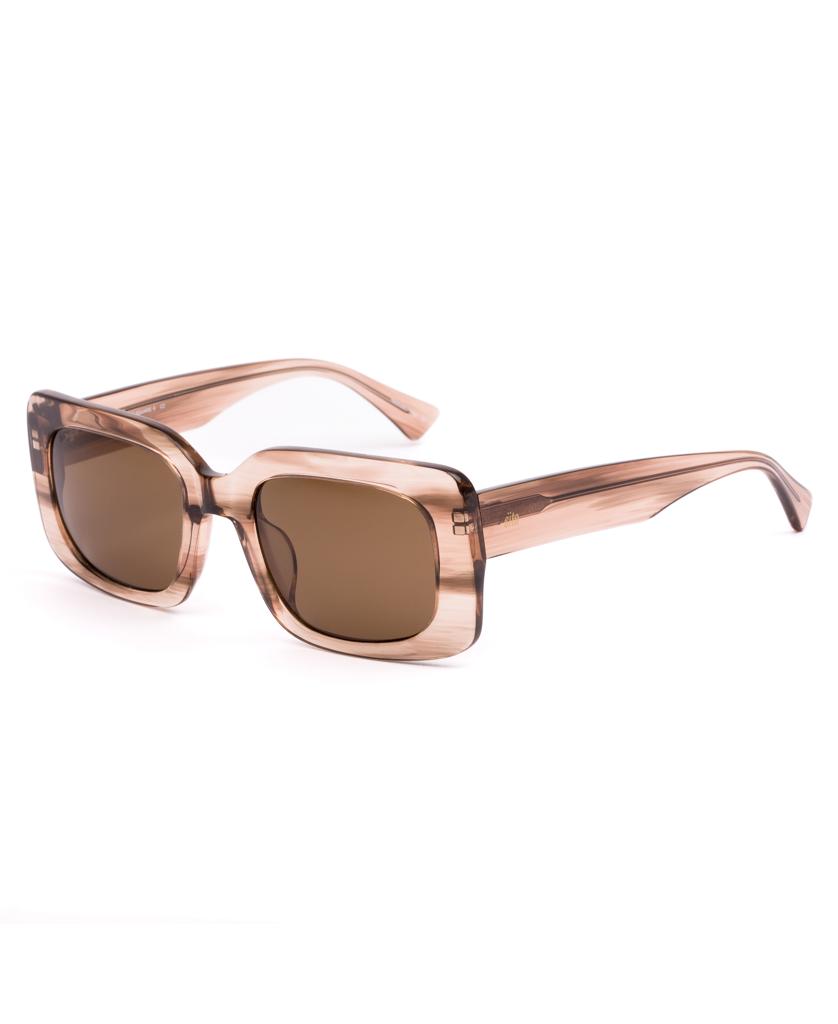 The Sito Indi sunglasses in Biscotti/Brown feature oversized, square, retro-inspired frames made of thick, translucent plastic. Shown at a three-quarter angle on a white background.