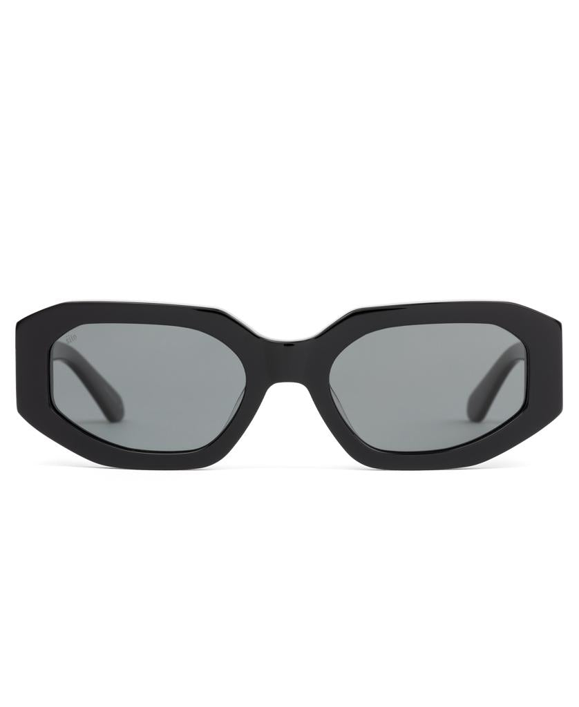 Front view of Sito Juicy sunglasses in Black / Iron Grey Polar, with geometric shape and dark lenses, crafted from handmade plant-based acetate for high UV protection, displayed against a white background.
