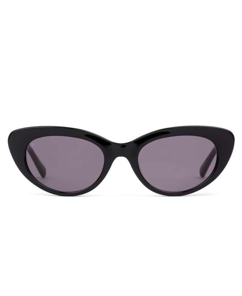 Sito Siena sunglasses in Black/Smokey Grey feature a cat-eye design, high UV protection, dark tinted lenses, and a plant-based acetate frame, shown from the front on a white background.