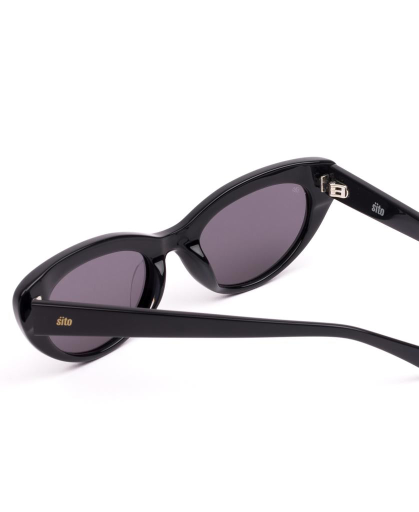 Sito Siena sunglasses in black with smokey grey lenses, shown angled on a white background. “Sito” branding appears on the temple and lens. Frame made from plant-based acetate for style and sustainability.