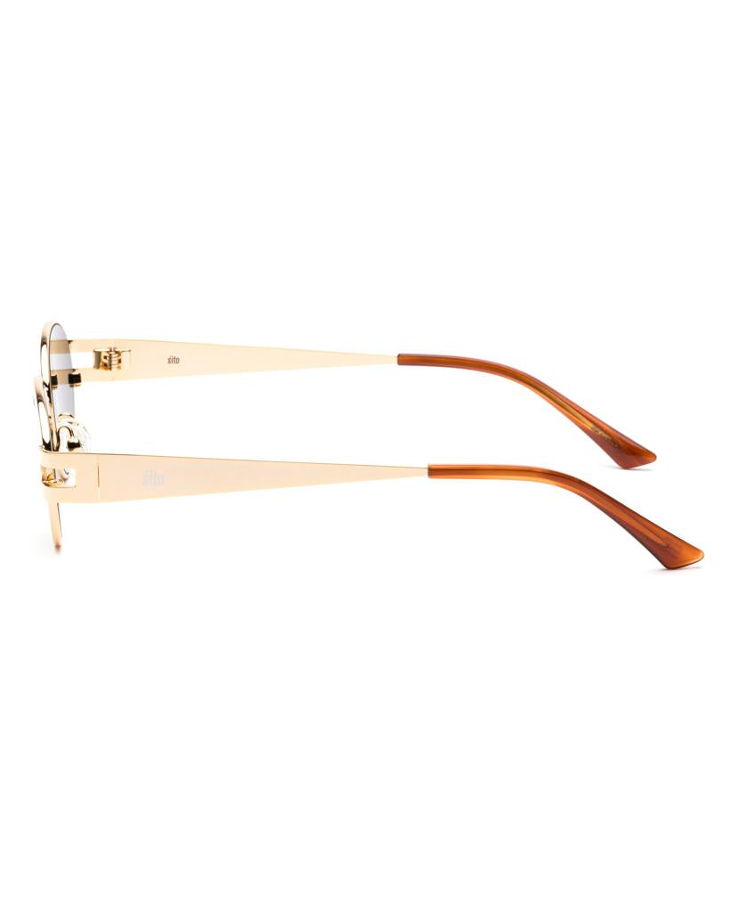 Side view of Sito Stevie gold-framed oval eyeglasses with slim metal arms and brown Tangelo tips. Can be customized with Slate Polar polarized lenses for enhanced sun protection.
