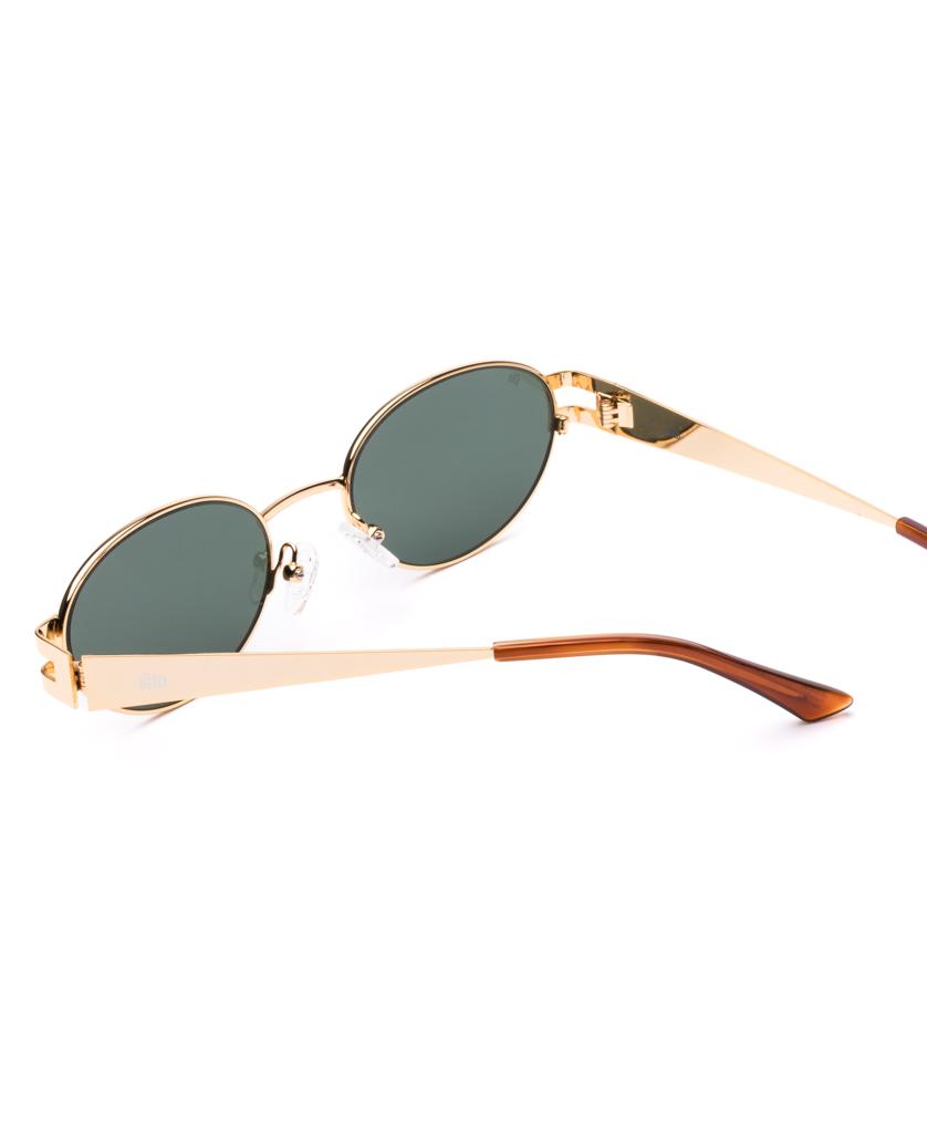 The Sito Stevie sunglasses feature gold metal frames, slate polar lenses, and Tangelo tortoiseshell brown temple tips, shown on a white background.