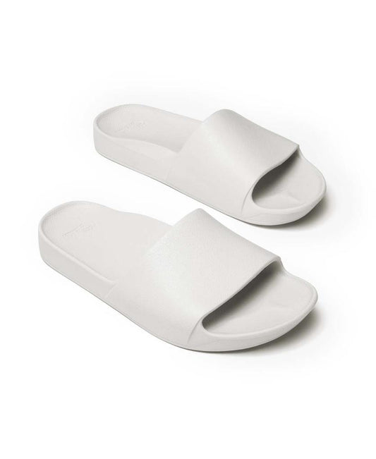 The Archie Slide | White by Archies features white open-toe slides with thick straps and arch support, providing all-day comfort. Photographed on a plain white background.