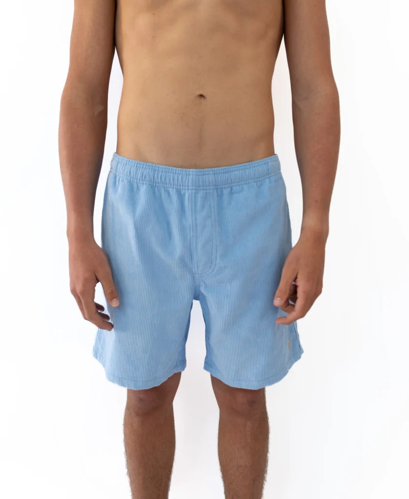 Front view of a male model wearing Floyd Cord Elastic Waist Walkshort | Blue Finch, featuring a light blue corduroy fabric with a comfortable elastic waistband, perfect for casual surfwear.